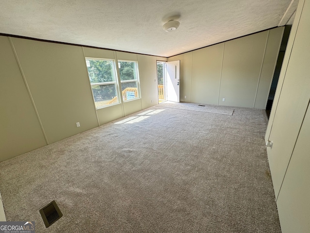 unfurnished bedroom featuring carpet flooring and a textured ceiling