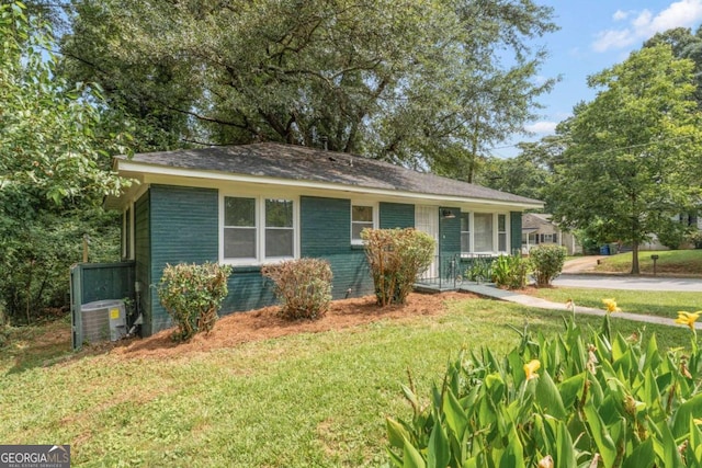 ranch-style house with central AC and a front lawn