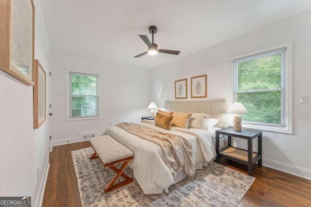 bedroom featuring multiple windows, ceiling fan, and dark wood-type flooring