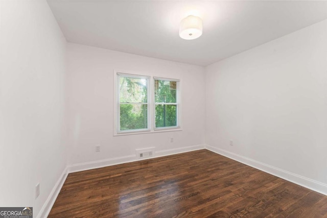 empty room featuring dark hardwood / wood-style flooring