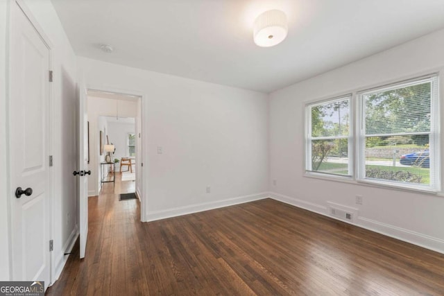 empty room featuring dark hardwood / wood-style flooring