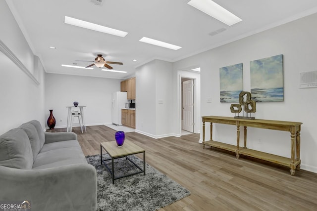 living room with ceiling fan, hardwood / wood-style flooring, and crown molding