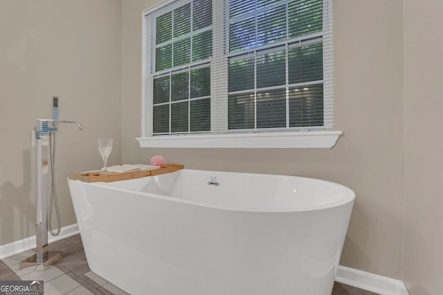 bathroom featuring a tub to relax in and tile patterned flooring