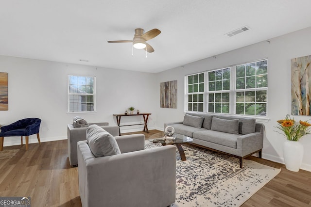 living room featuring ceiling fan and hardwood / wood-style flooring