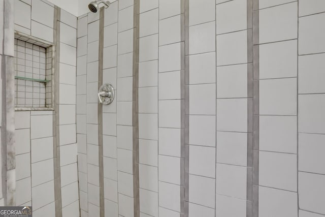 bathroom with a tile shower