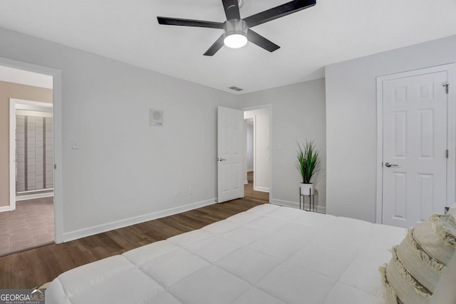 bedroom with ceiling fan and dark hardwood / wood-style floors