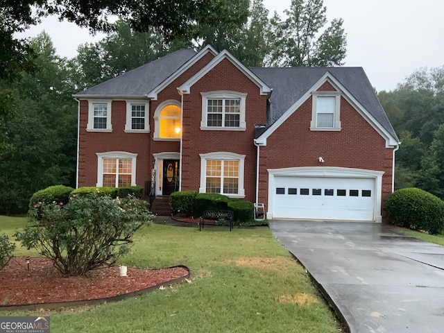 colonial inspired home featuring a garage and a front yard