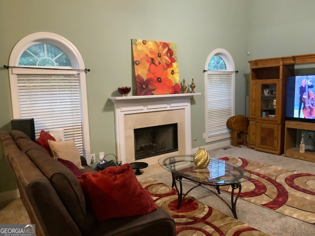 carpeted living room featuring a premium fireplace, ceiling fan, and lofted ceiling