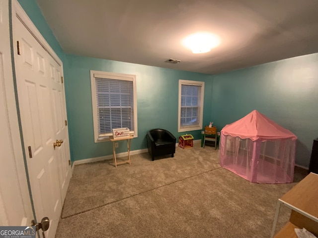 bedroom with ornamental molding, light carpet, ceiling fan, and a tray ceiling