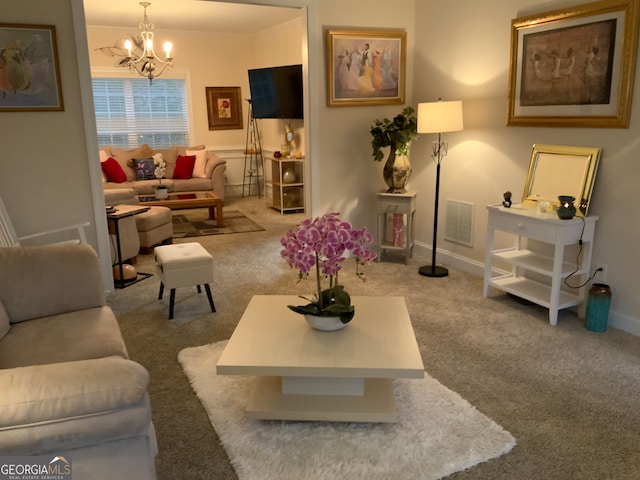 carpeted living room featuring a chandelier