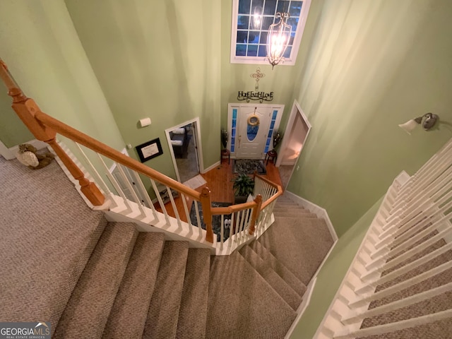 living room with wood-type flooring, a chandelier, and crown molding