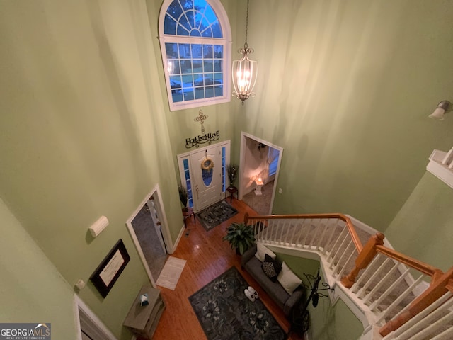 stairway with carpet, ceiling fan with notable chandelier, and crown molding