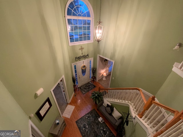 staircase featuring ornamental molding and a chandelier