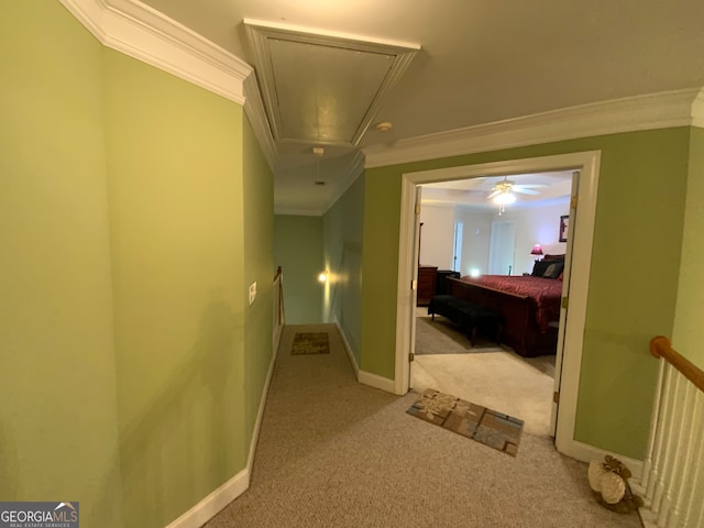 hallway with light carpet and crown molding