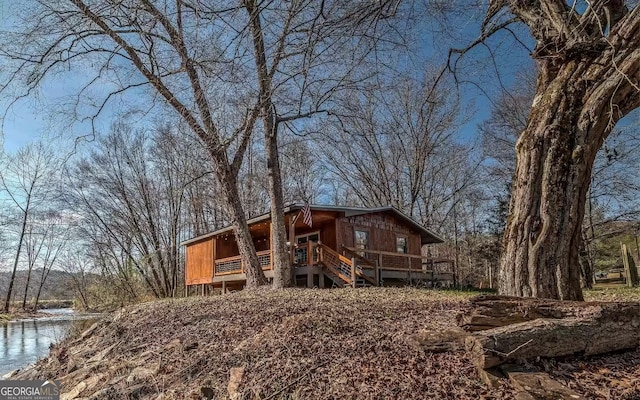 view of front of house featuring a deck with water view