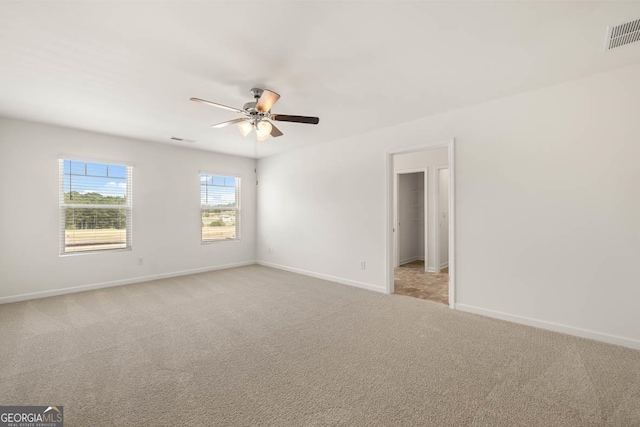 unfurnished room featuring ceiling fan and light carpet