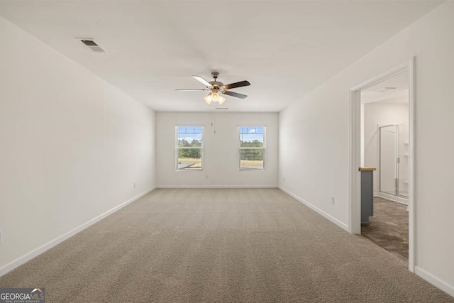 carpeted empty room featuring ceiling fan