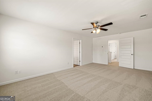 unfurnished room with ceiling fan and light carpet