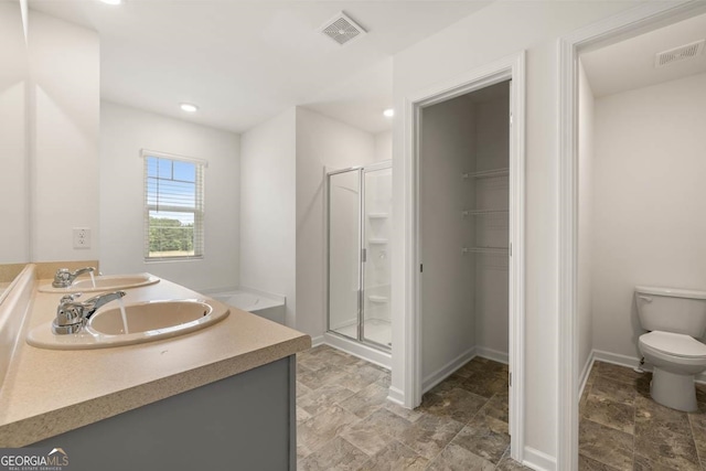 bathroom with vanity, toilet, and an enclosed shower