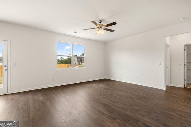 spare room featuring ceiling fan and dark hardwood / wood-style flooring