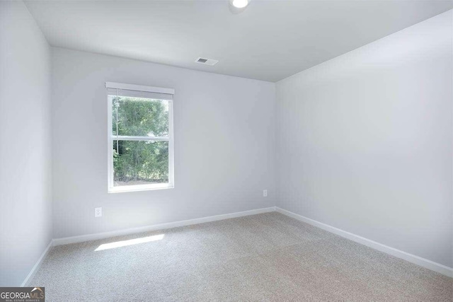 empty room with plenty of natural light and carpet