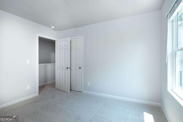 unfurnished bedroom featuring light colored carpet