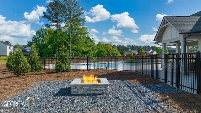 view of yard with a fenced in pool and an outdoor fire pit