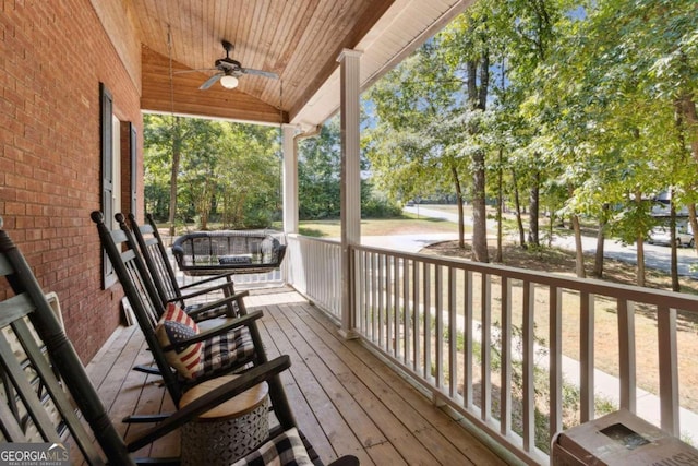 deck featuring a porch and a ceiling fan