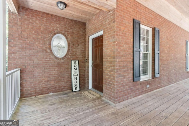 doorway to property with brick siding