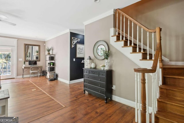 entryway with stairway, wood finished floors, baseboards, and ornamental molding