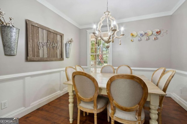 dining area with a chandelier, wainscoting, dark wood-type flooring, and ornamental molding