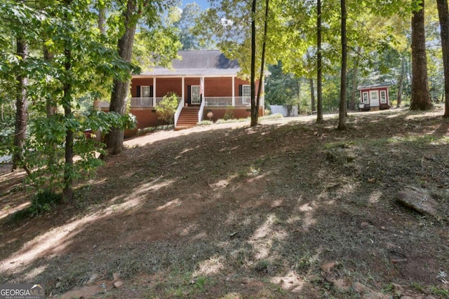 view of front of property with a porch and stairs