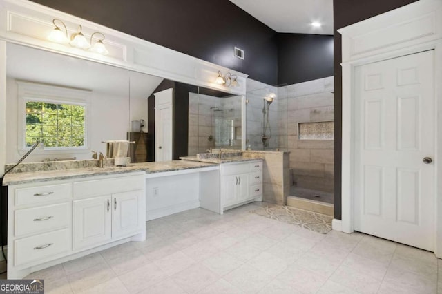 full bath featuring vanity, visible vents, and walk in shower