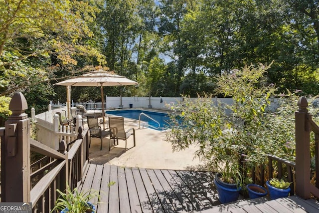 view of pool featuring a wooden deck, a fenced in pool, and a fenced backyard