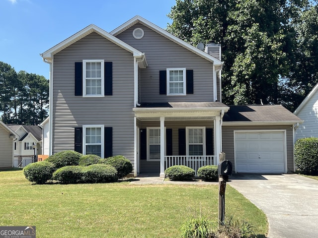 front of property featuring a garage, a front yard, and covered porch