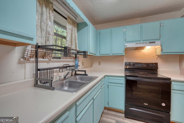 kitchen with a textured ceiling, black / electric stove, blue cabinetry, light hardwood / wood-style floors, and sink