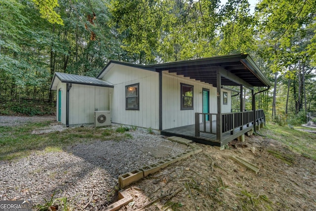 view of outbuilding featuring ac unit and covered porch