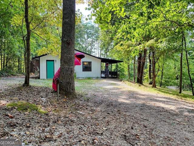 view of side of home with a carport