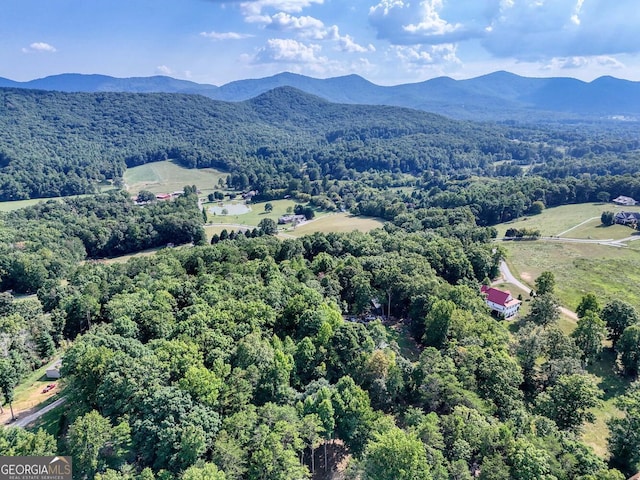 aerial view with a mountain view and a forest view