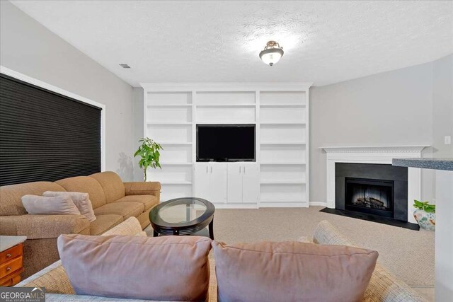 carpeted living room featuring a textured ceiling