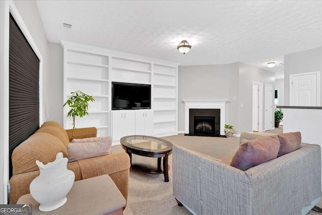 living room with a textured ceiling, light carpet, and built in features