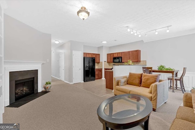 living room with a fireplace with flush hearth and a textured ceiling