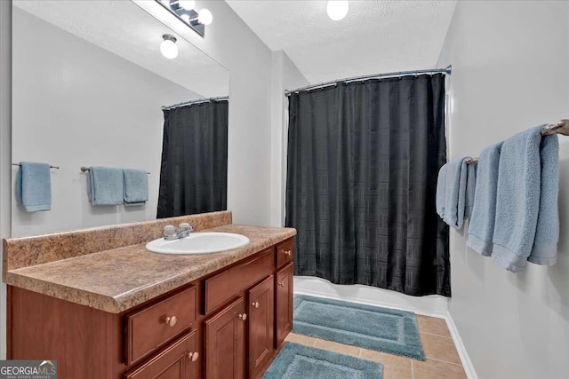 bathroom featuring a textured ceiling, vanity, tile patterned floors, and shower / bath combo