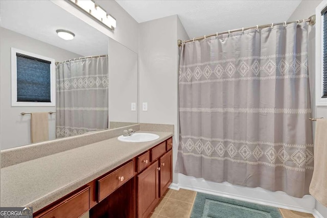 bathroom featuring tile patterned flooring, vanity, and shower / bath combo with shower curtain