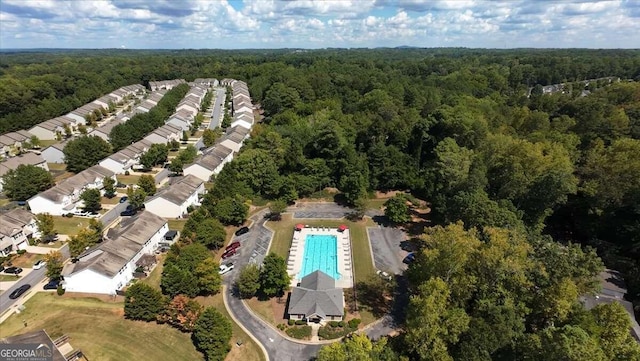 birds eye view of property featuring a view of trees