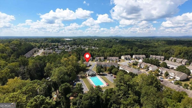 birds eye view of property with a view of trees