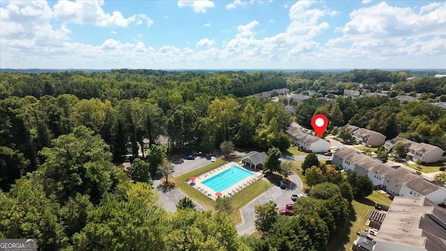 birds eye view of property with a view of trees