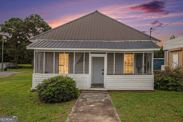 view of front of home featuring a lawn and covered porch