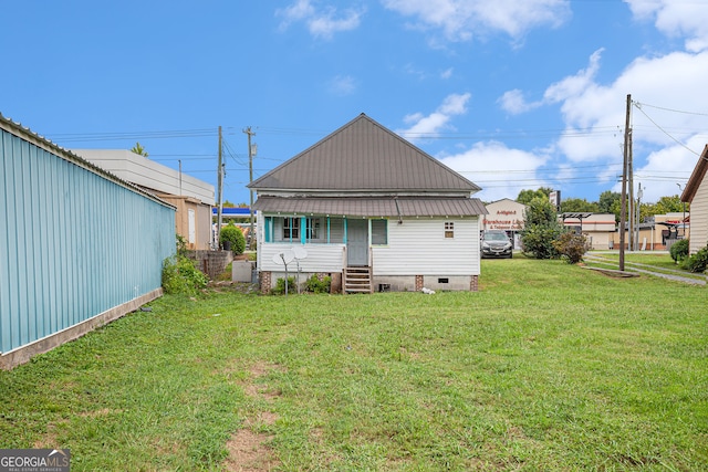 rear view of house with a yard