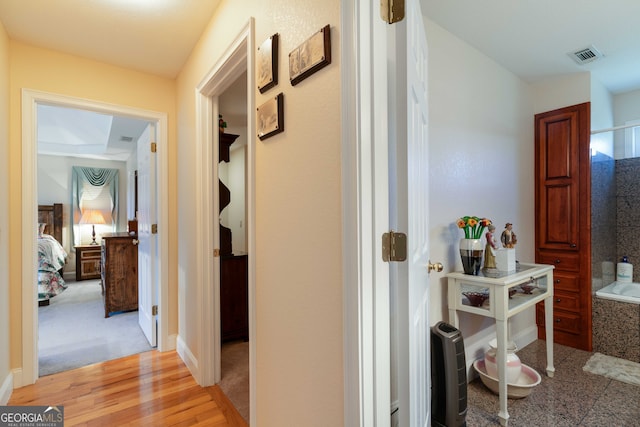 hallway with light hardwood / wood-style flooring